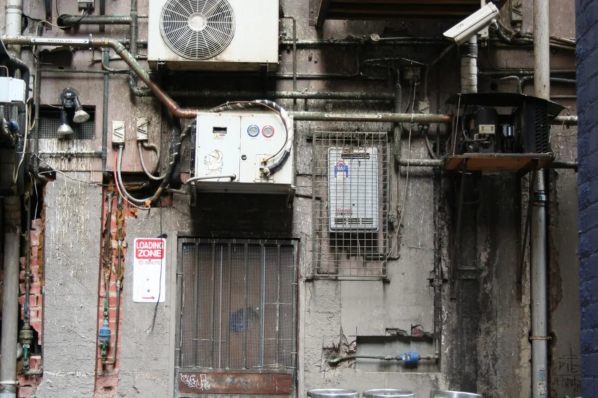 Outdoor air conditioner condenser units mounted on an exterior wall