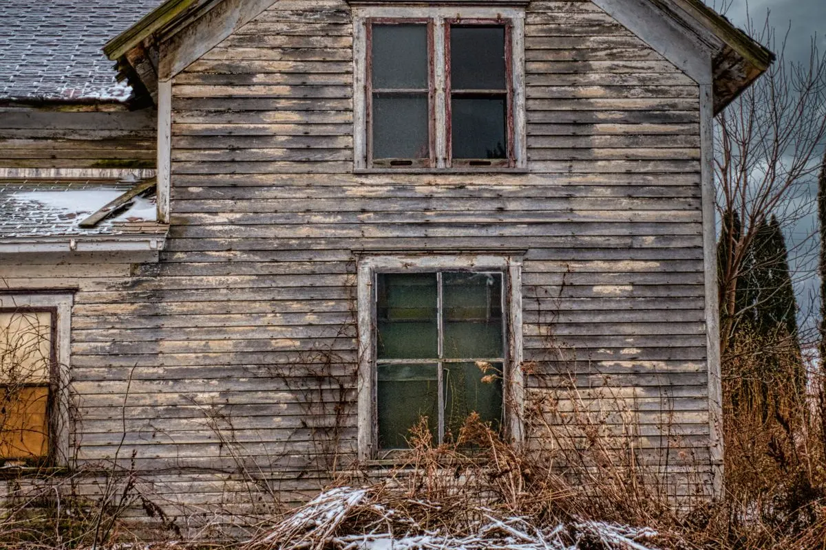 Rustic old house covered in snow during winter