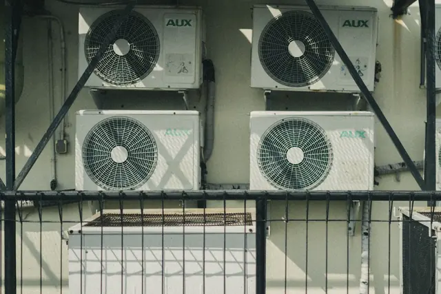 Multiple outdoor air conditioner and heat pump units mounted outside a building
