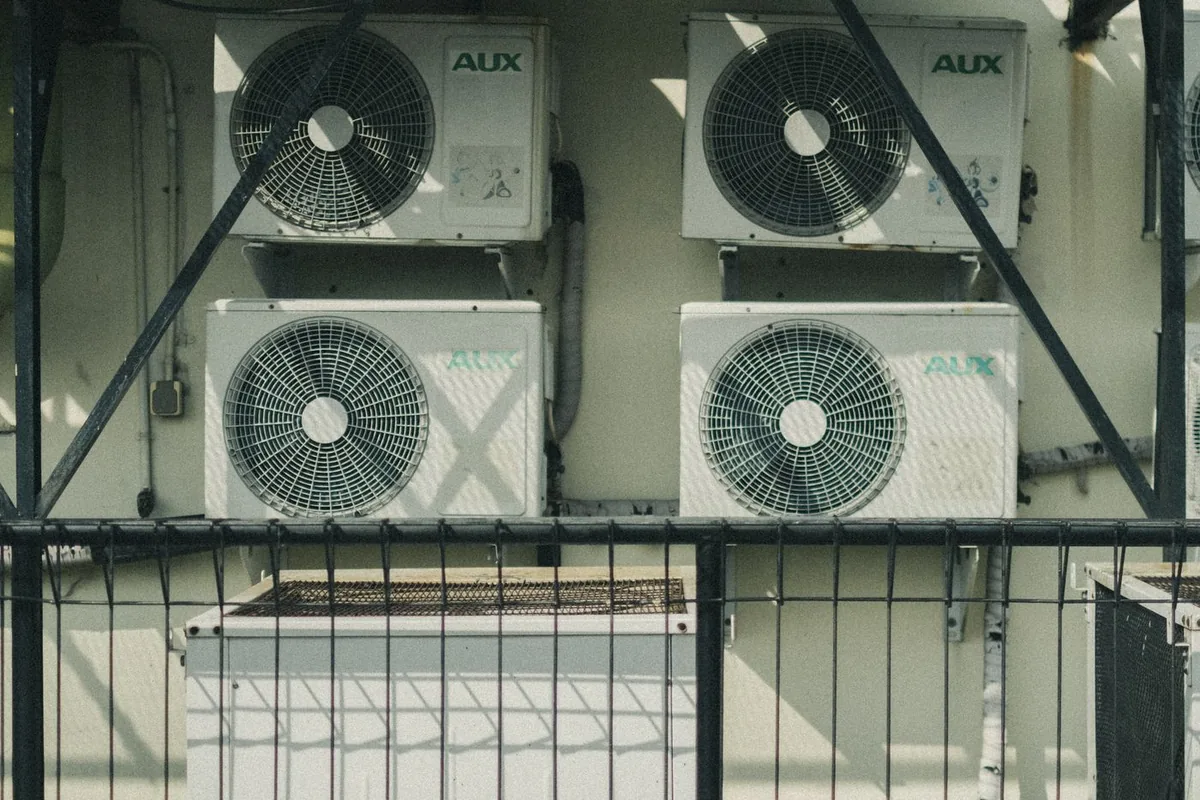 Multiple outdoor air conditioner and heat pump units mounted outside a building